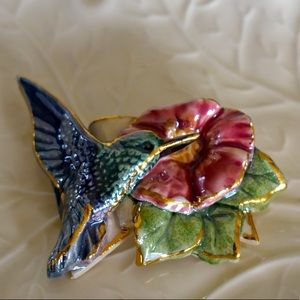 Handmade clay hummingbird at flower pin